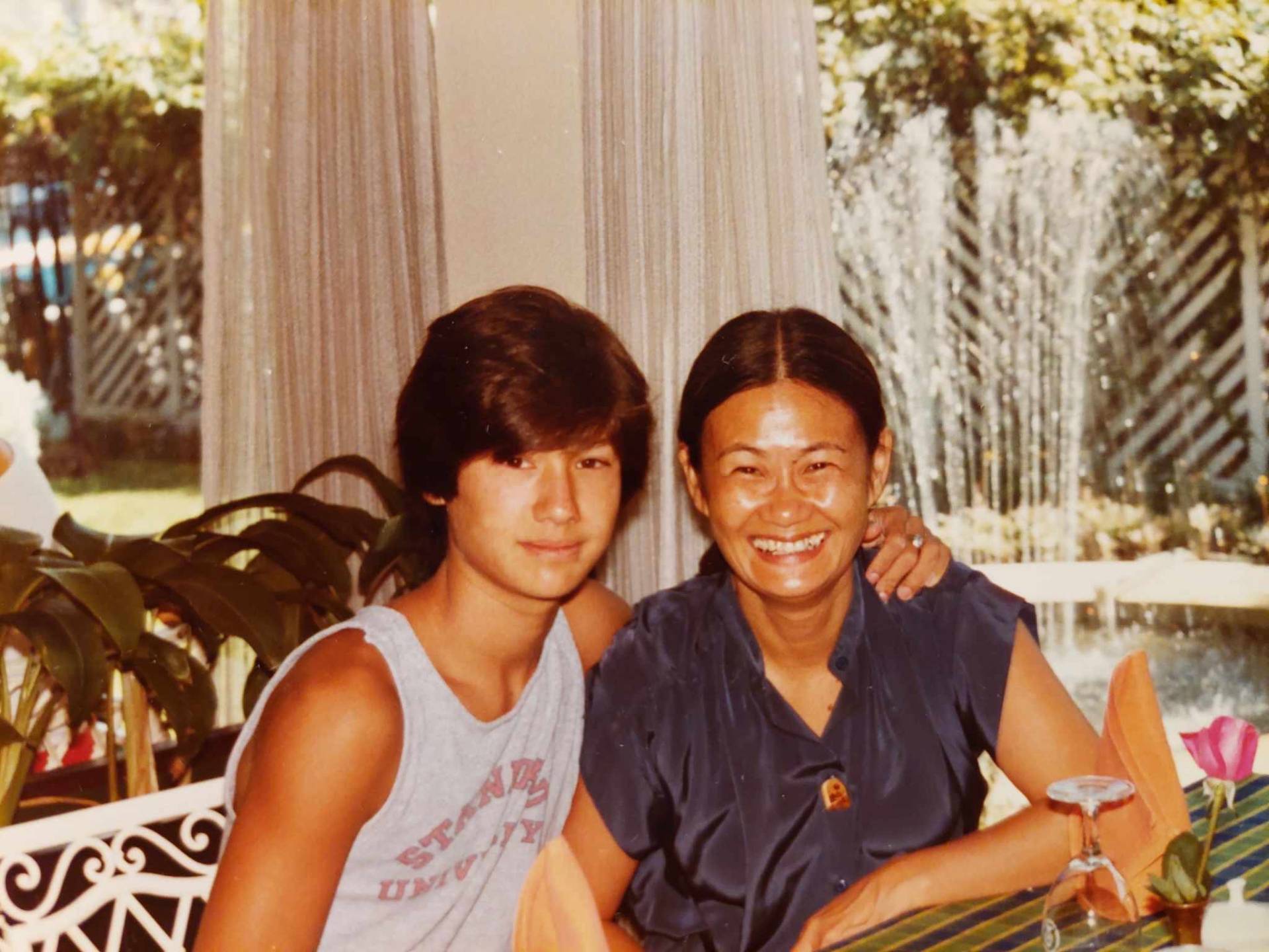 David as a teenager with his mother, Samphan, at a garden restaurant